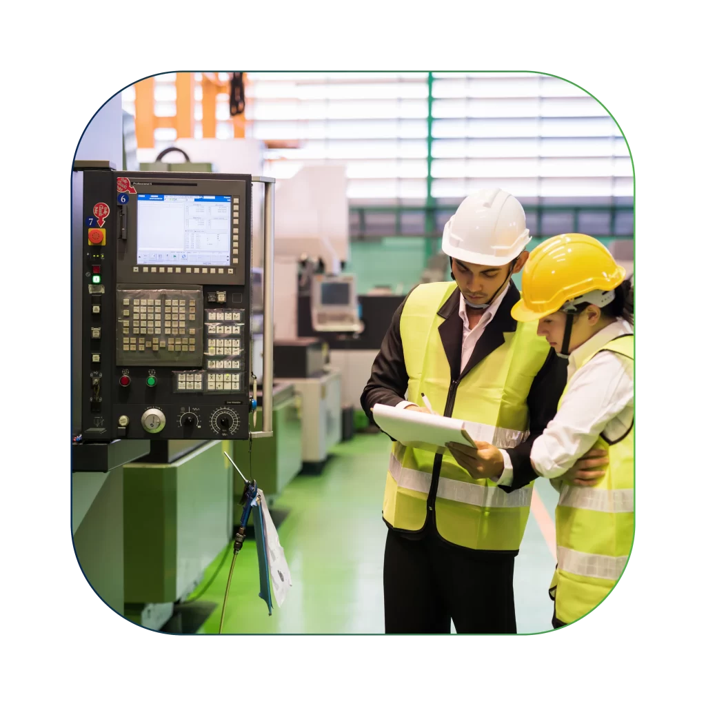 Engineers in safety vests and helmets reviewing documents beside industrial control equipment optical analytics