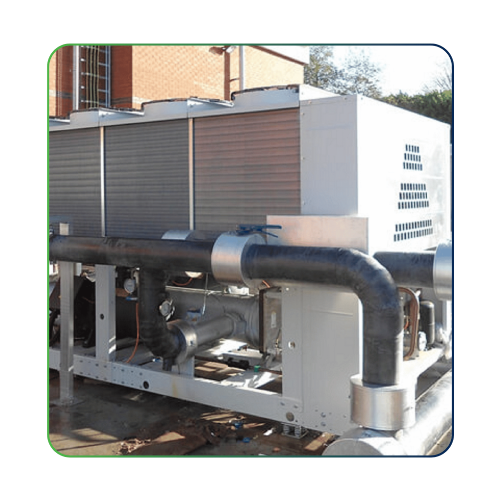 IoT Solution - OptiEdgeCPM (chiller plant manager). Industrial chiller system with black pipelines.